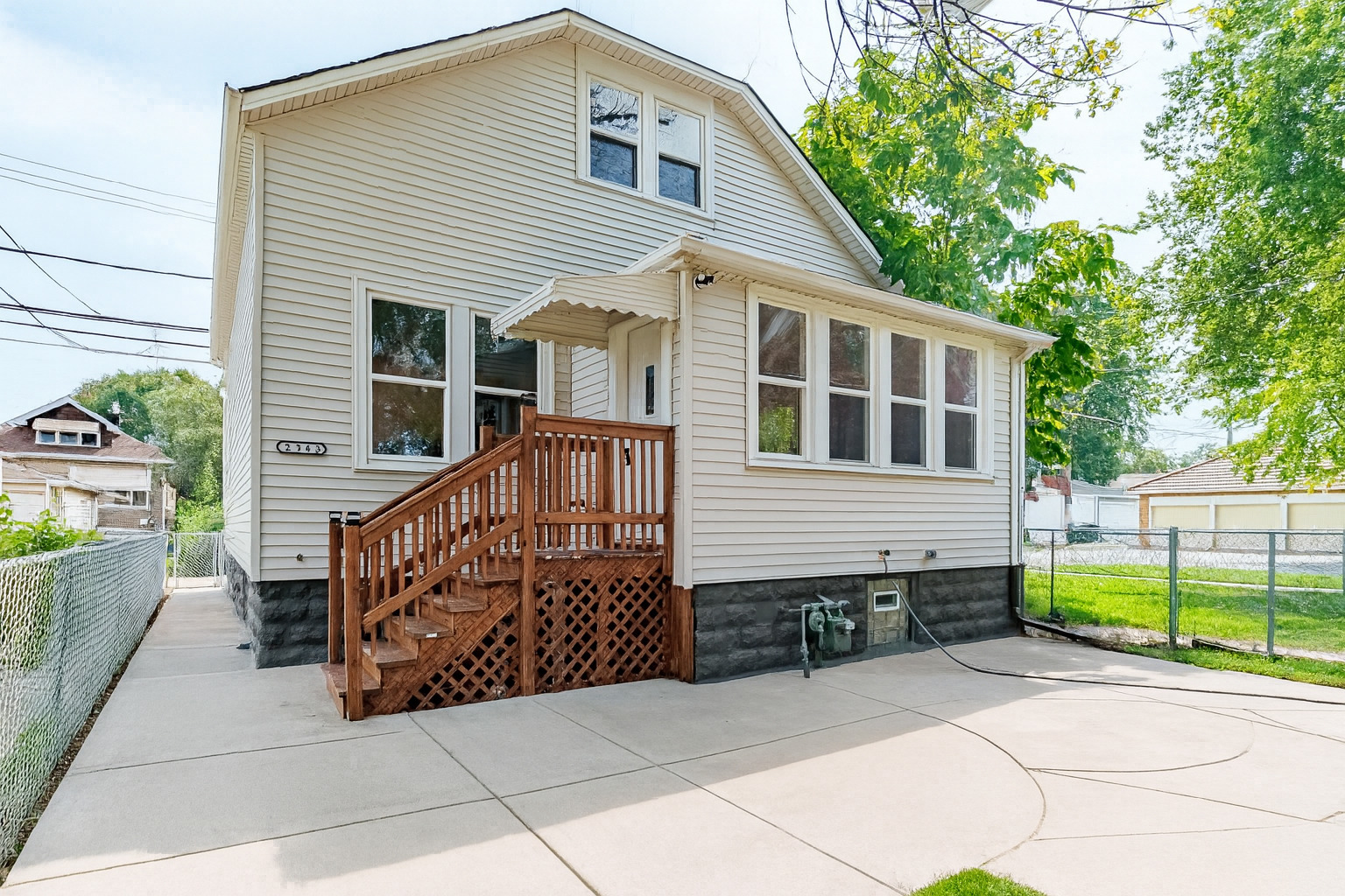 a view of a house with a small yard and wooden fence