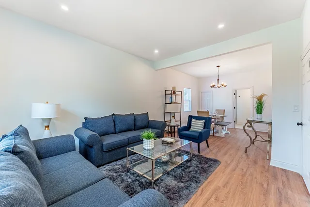 a living room with furniture and wooden floor