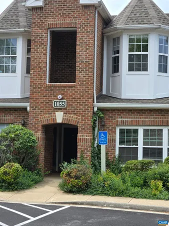 a view of a brick house with a yard and large window