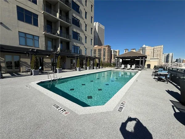 a view of a swimming pool with outdoor seating