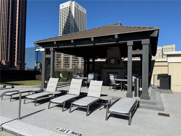 a building outdoor space with patio furniture and white walls