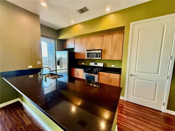 a kitchen with a sink appliances and cabinets
