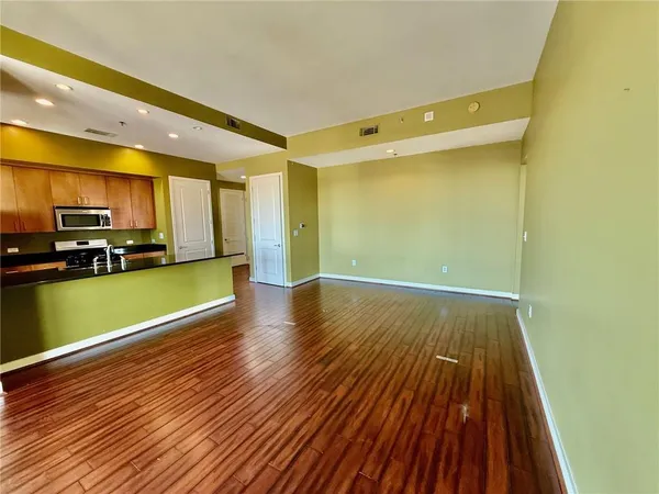 a view of a kitchen with wooden floor and a sink
