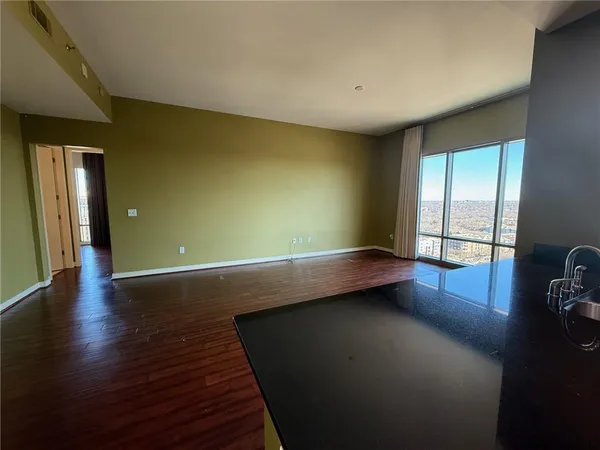 a view of room with window and wooden floor