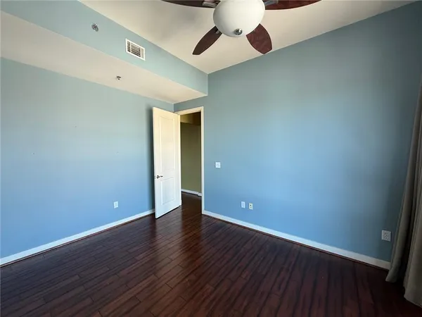 a view of an empty room with wooden floor