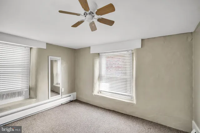 a view of room with a ceiling fan and window