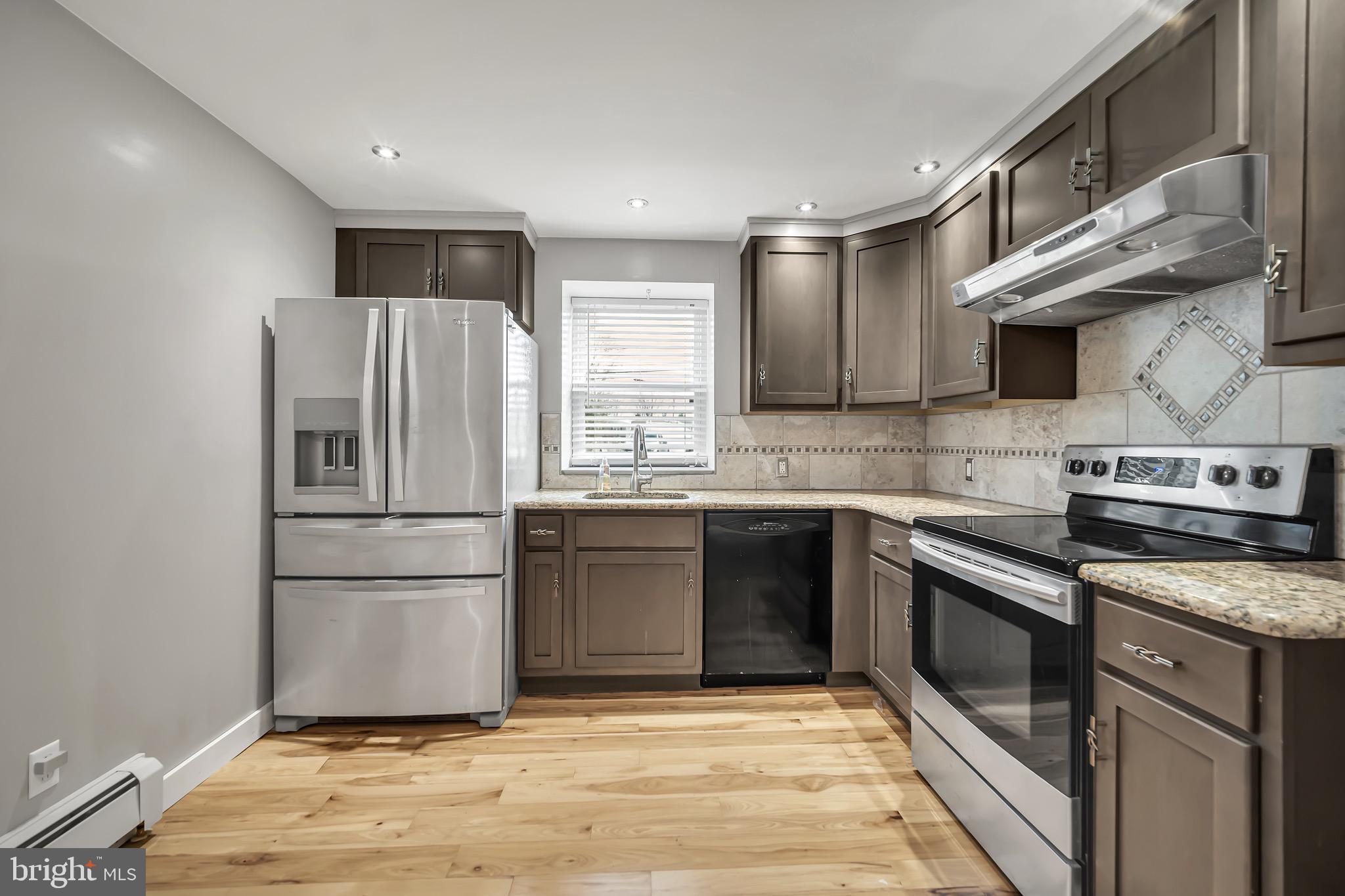 246 Cottage Avenue, Unit A Horsham, PA 19044 - Photo 6 of 21 a kitchen with granite countertop a refrigerator and a stove top oven