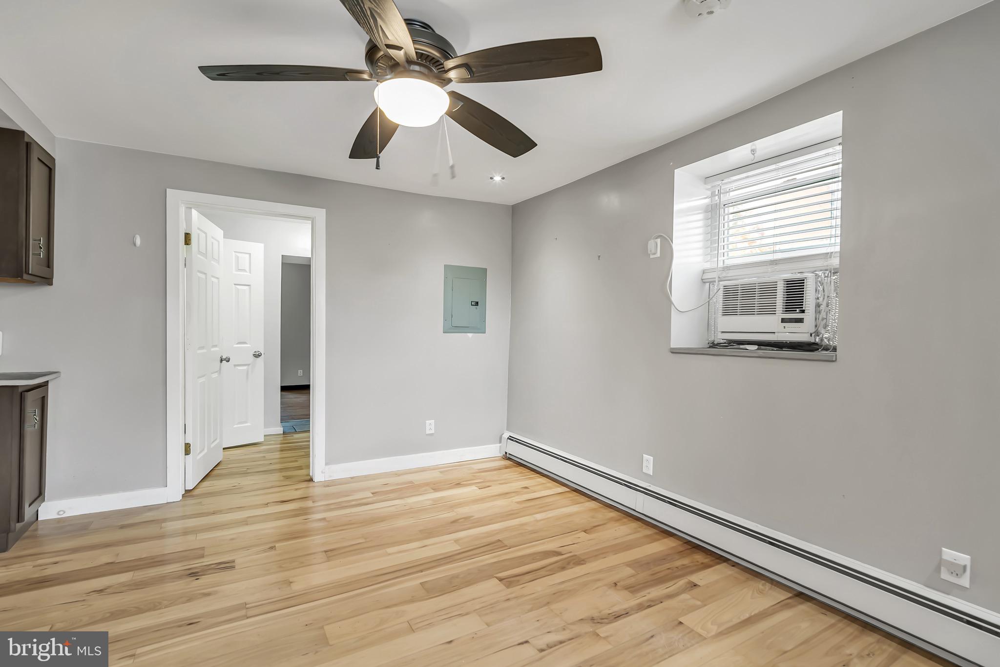 246 Cottage Avenue, Unit A Horsham, PA 19044 - Photo 7 of 21 an empty room with wooden floor a ceiling fan and windows