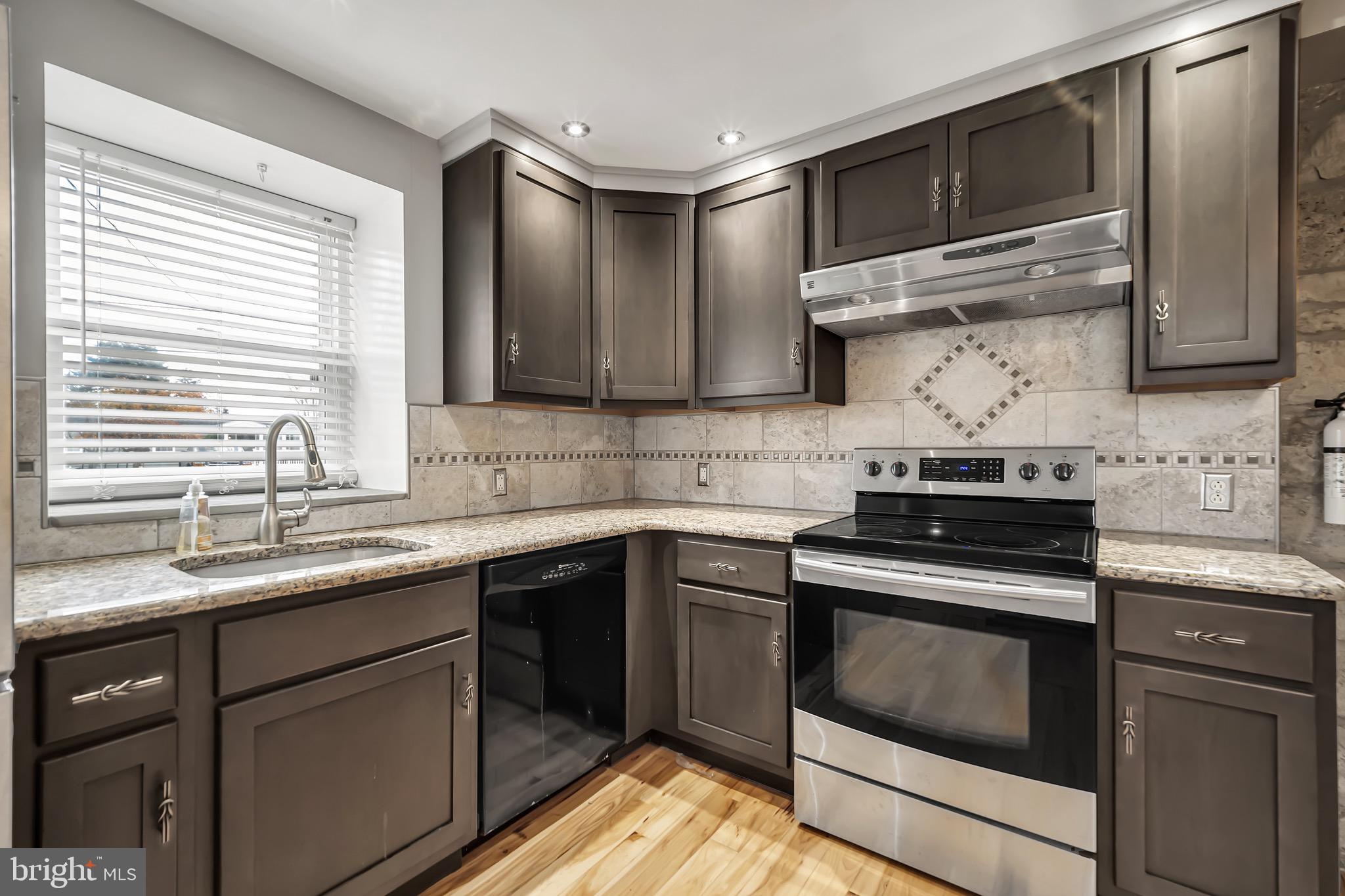 246 Cottage Avenue, Unit A Horsham, PA 19044 - Photo 8 of 21 a kitchen with stainless steel appliances granite countertop a sink and a stove
