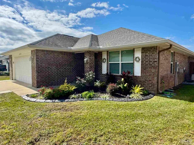 a front view of a house with garden
