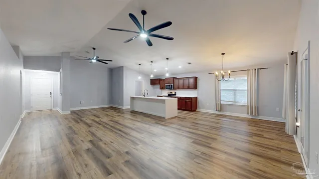 a kitchen with a sink a microwave and cabinets