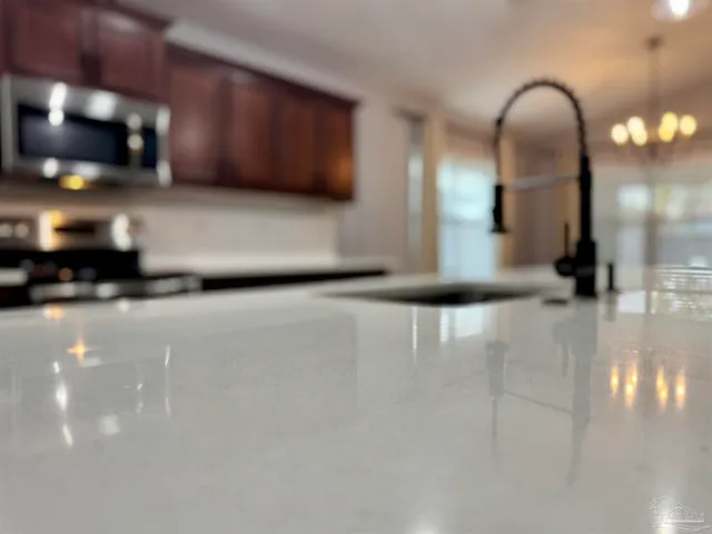 a kitchen with a sink stove and cabinets