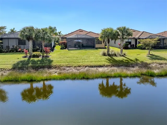 a view of a lake with houses in the background