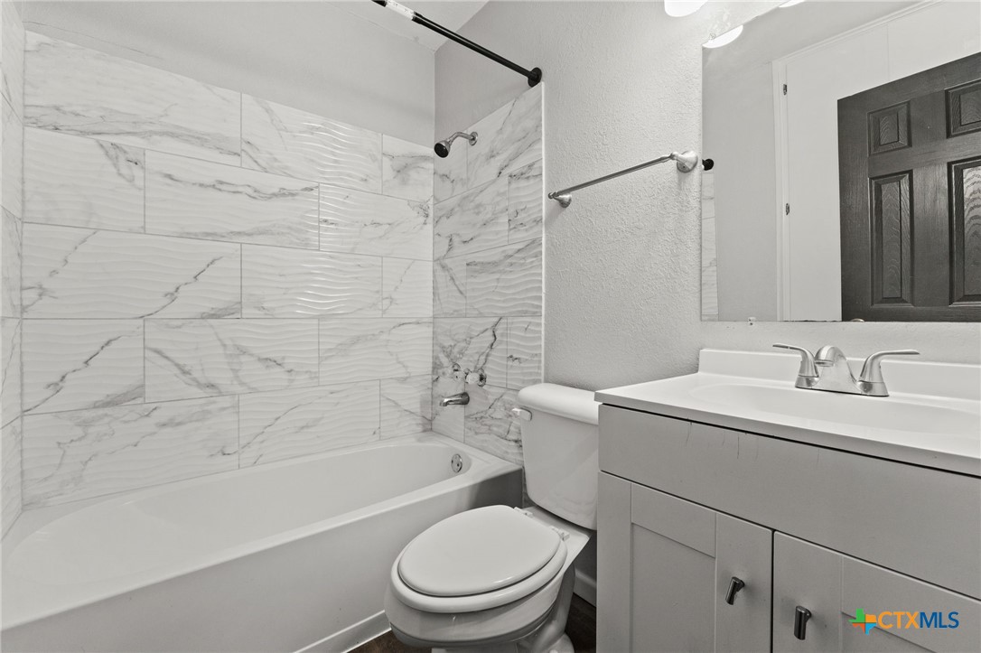 1401 Stephen Street Killeen, TX 76549 - Photo 12 of 27 a bathroom with a sink toilet vanity and shower