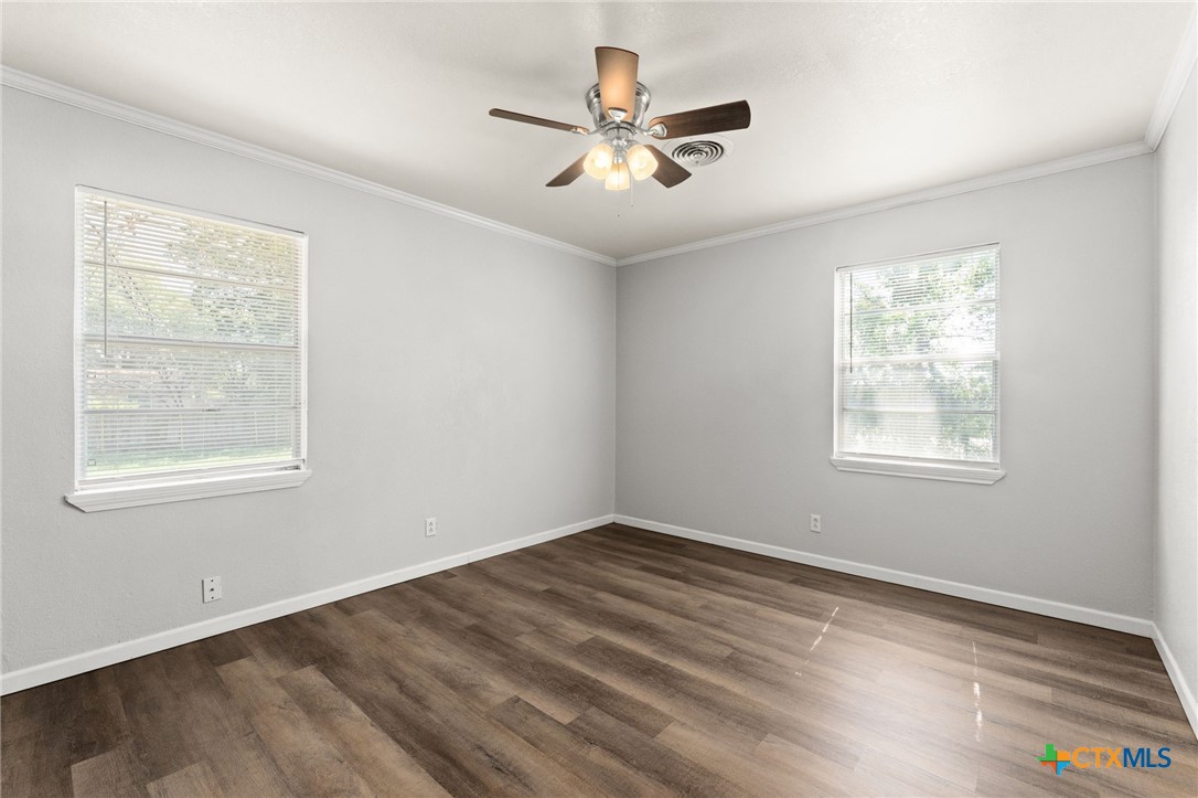 1401 Stephen Street Killeen, TX 76549 - Photo 13 of 27 a view of empty room with wooden floor and fan