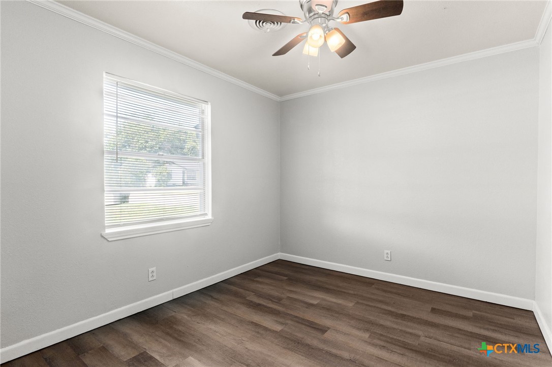 1401 Stephen Street Killeen, TX 76549 - Photo 20 of 27 an empty room with wooden floor fan and windows