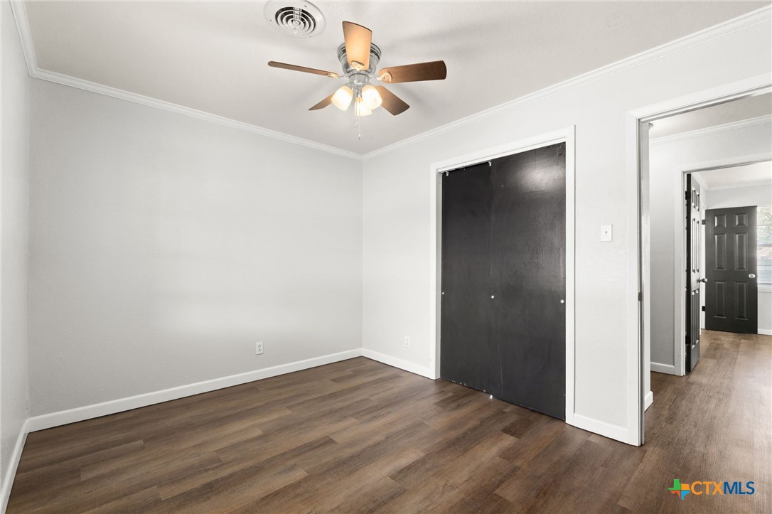 1401 Stephen Street Killeen, TX 76549 - Photo 21 of 27 an empty room with wooden floor and a ceiling fan