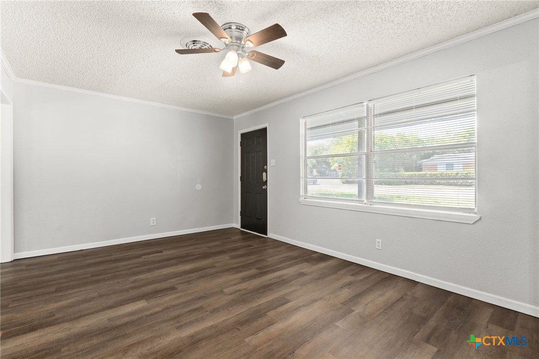 1401 Stephen Street Killeen, TX 76549 - Photo 5 of 27 a view of an empty room with wooden floor and a window