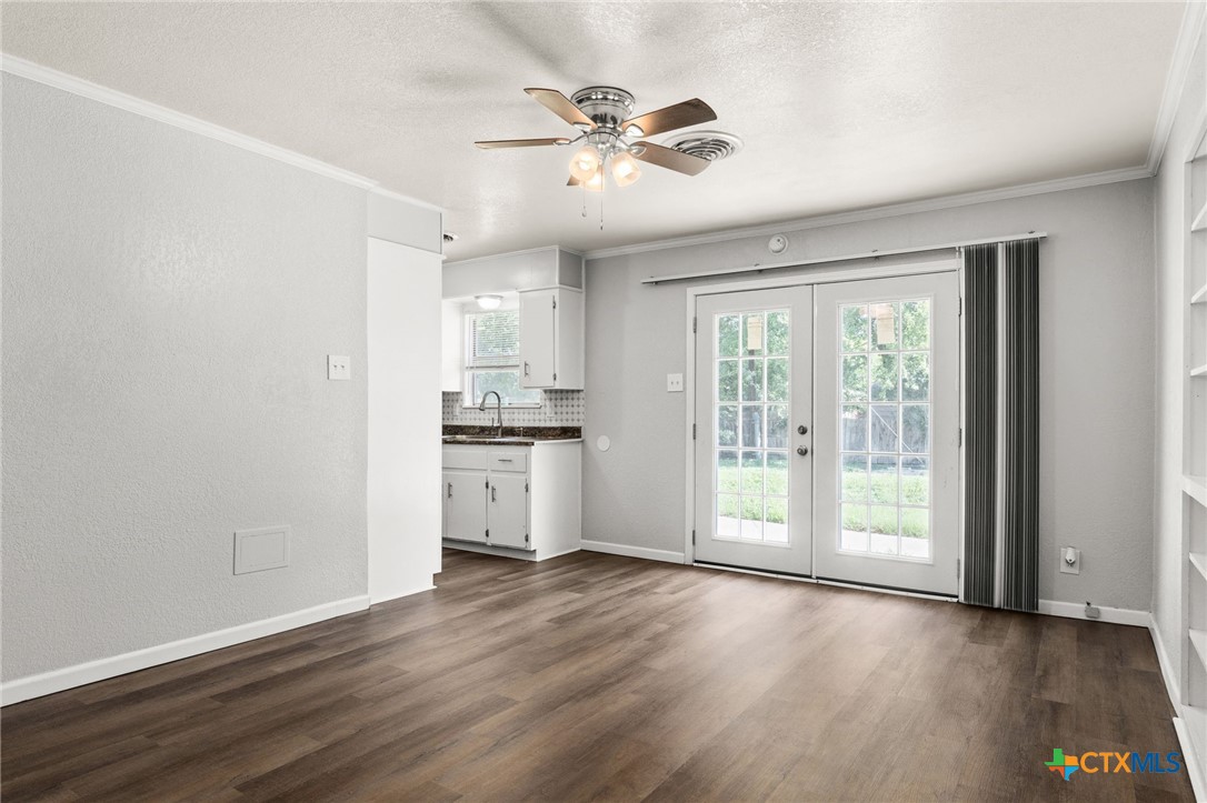 1401 Stephen Street Killeen, TX 76549 - Photo 8 of 27 a view of an empty room with a window and wooden floor