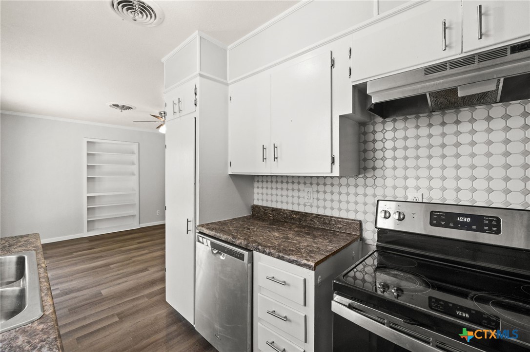 1401 Stephen Street Killeen, TX 76549 - Photo 10 of 27 a kitchen with granite countertop a stove and a cabinets