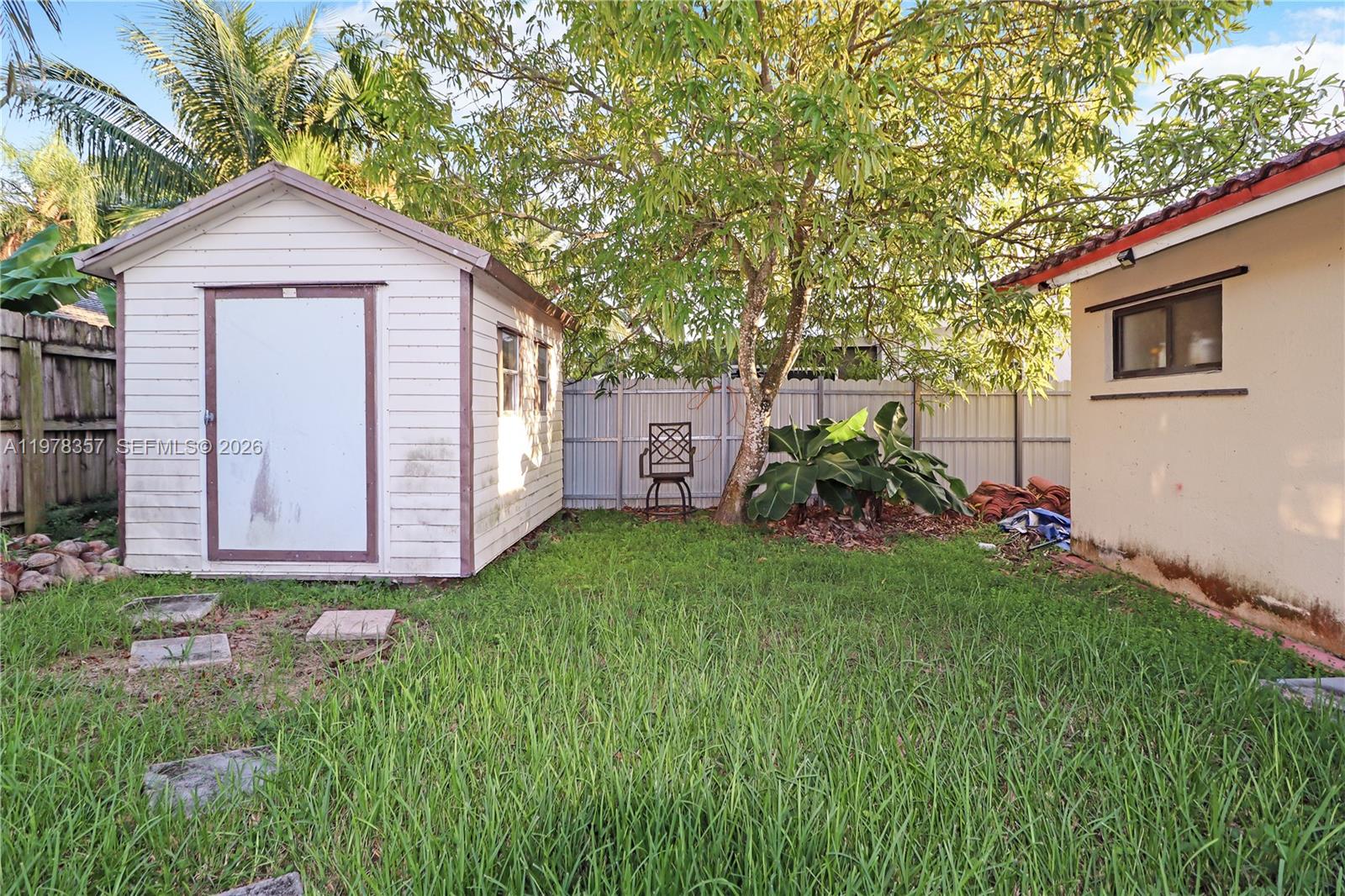 15255 Southwest 99th Court Miami, FL 33157 - Photo 17 of 18 a front view of a house with garden