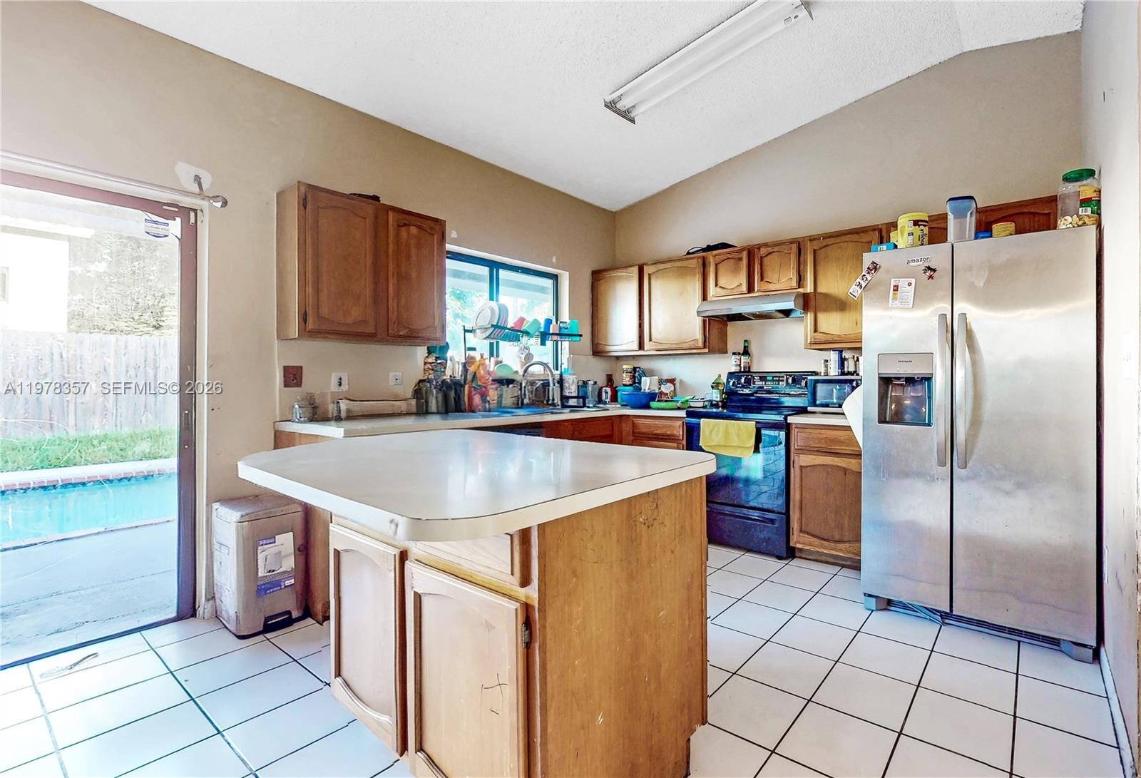 15255 Southwest 99th Court Miami, FL 33157 - Photo 5 of 18 a kitchen with stainless steel appliances granite countertop a refrigerator a sink a stove top oven a counter space and cabinets