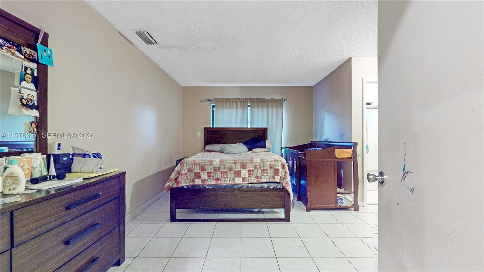 15255 Southwest 99th Court Miami, FL 33157 - Photo 8 of 18 a bedroom with a bed and a dresser