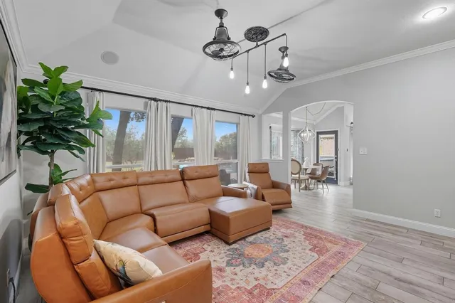 a living room with furniture potted plant and a chandelier