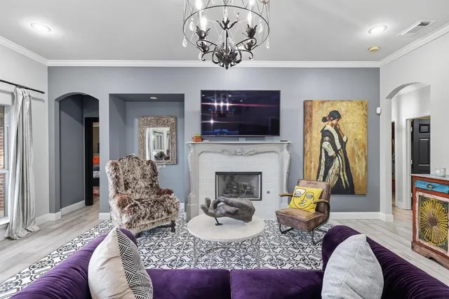 a living room with furniture a flat screen tv and a fireplace