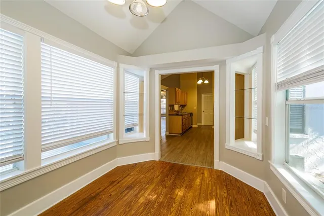 a view of a livingroom with wooden floor and a large window