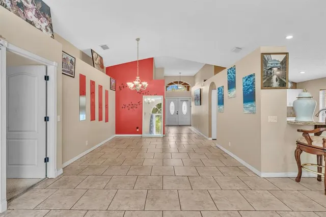 a view of a hallway with dining area