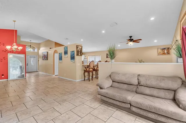 a living room with furniture and a chandelier