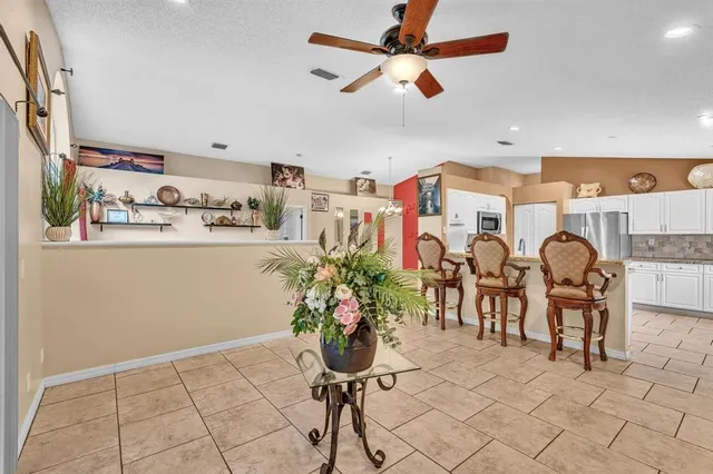 a living room with furniture and potted plant