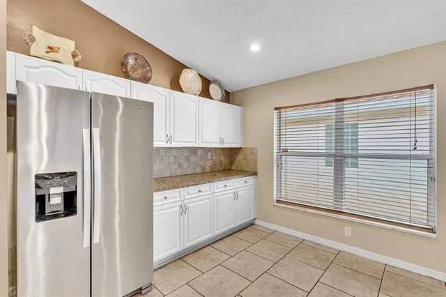 a kitchen with stainless steel appliances granite countertop a refrigerator and a stove