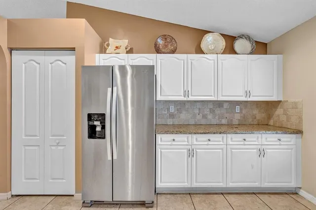 a bathroom with a granite countertop sink a bathtub and shower