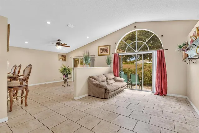 a view of living room filled with furniture and a large window