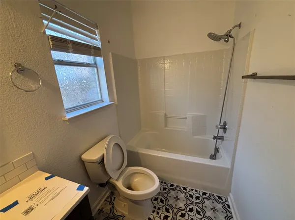 a bathroom with a sink a toilet and a bathtub