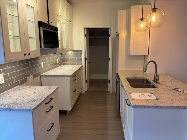 a kitchen with a sink stove and refrigerator