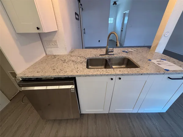 a kitchen with a sink and a stove