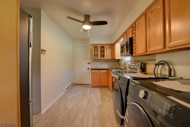 a kitchen with a sink appliances and cabinets