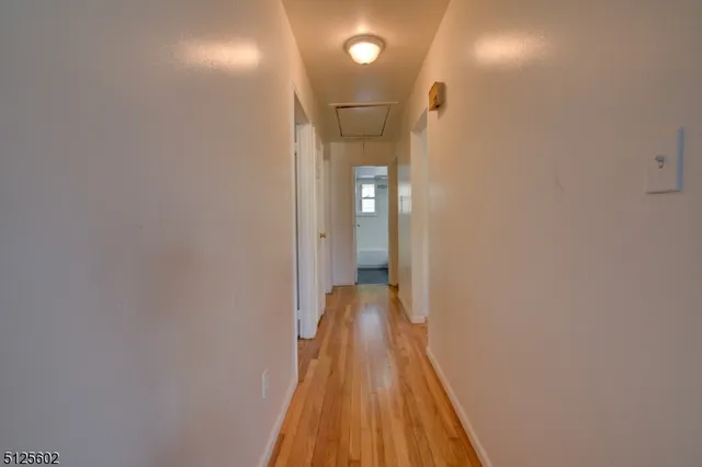 a view of a bathroom with a sink and wooden floor