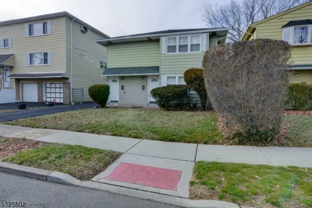 a view of a house with a yard and plants