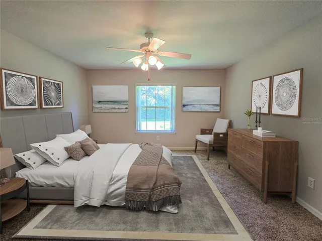 a bedroom with a bed couches and window