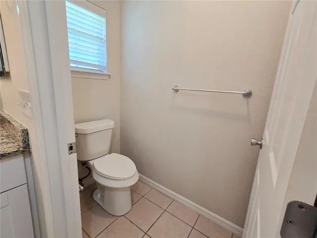 a white toilet sitting next to a sink