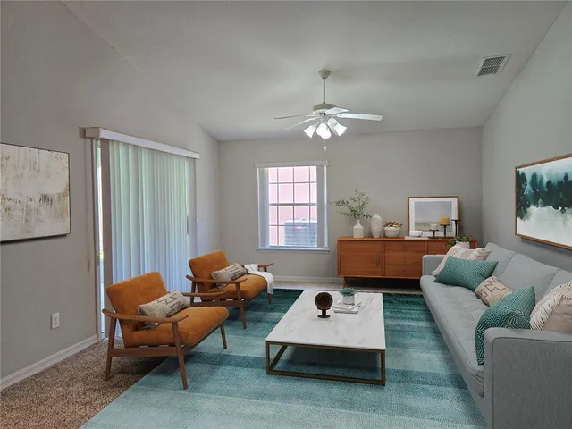 a living room with furniture and a chandelier