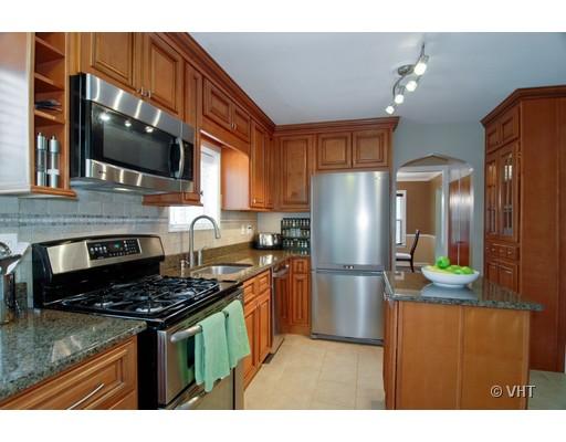 215 Akenside Road Riverside, IL 60546 - Photo 3 of 14 a kitchen with stainless steel appliances granite countertop a stove refrigerator and microwave