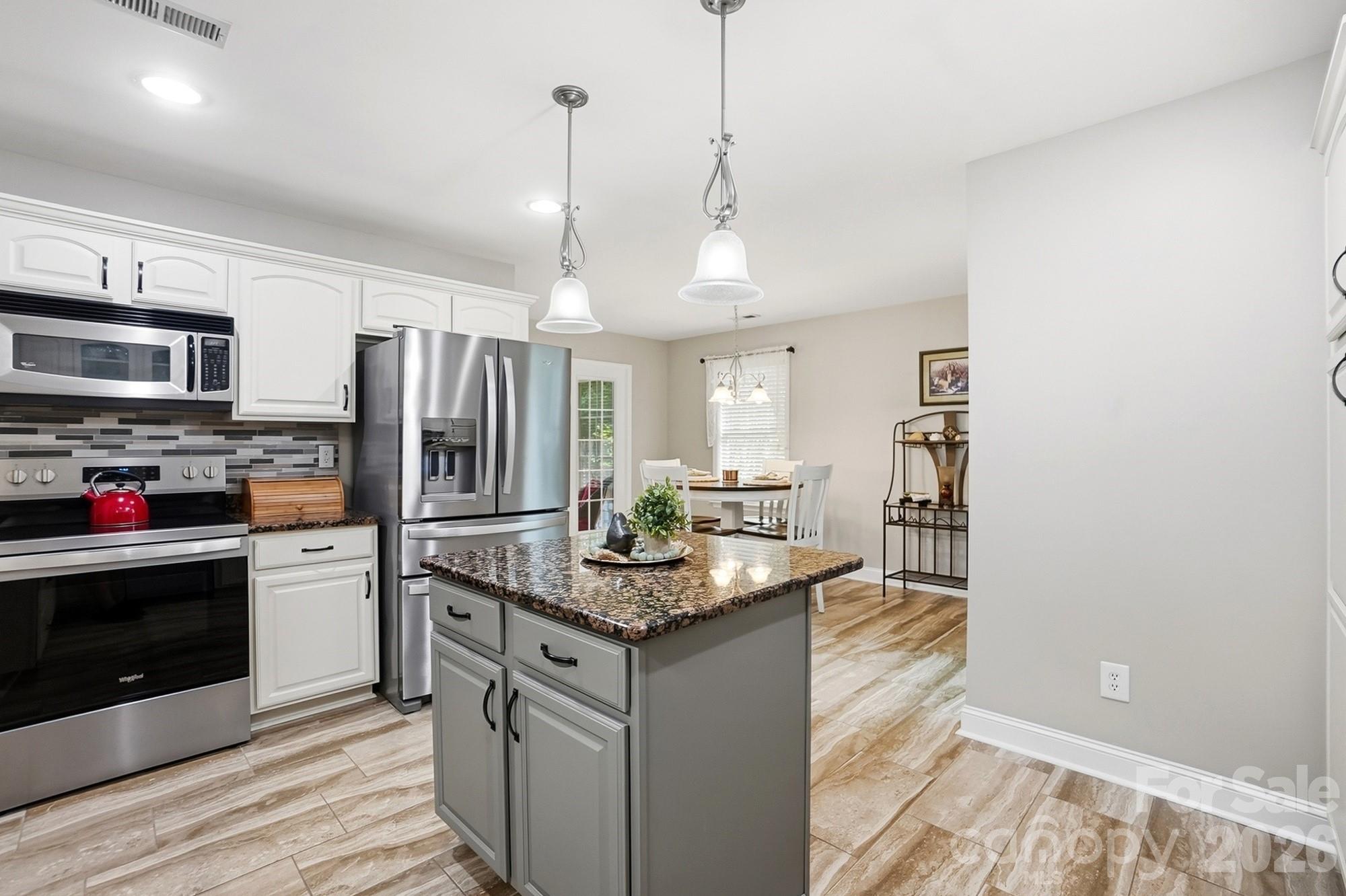 3324 Muddy Creek Road Midland, NC 28107 - Photo 14 of 46 a kitchen with stainless steel appliances granite countertop a refrigerator a stove and a sink
