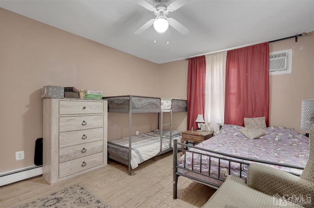 141 Winthrop Road Edison, NJ 08817 - Photo 23 of 30 a bedroom with furniture and a chandelier