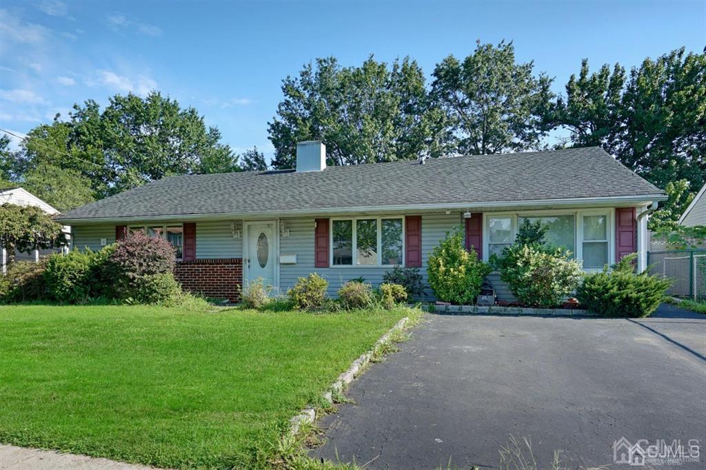 141 Winthrop Road Edison, NJ 08817 - Photo 5 of 30 a front view of a house with garden and trees