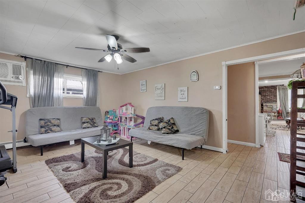 141 Winthrop Road Edison, NJ 08817 - Photo 7 of 30 a living room with furniture and wooden floor